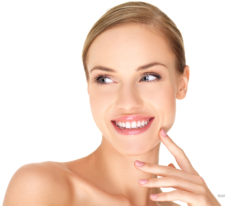 smiling adult woman with smooth facial skin and bare shoulders