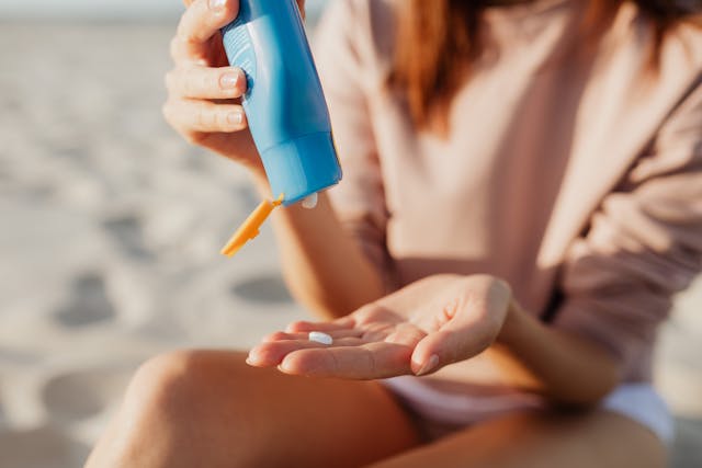 a woman applying SPF on her hand.