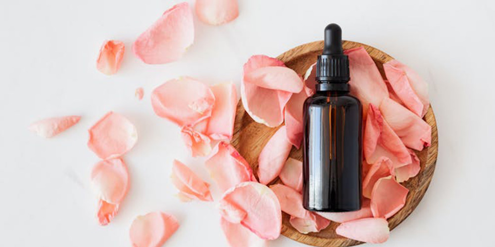 a skin care product and rose petals around it