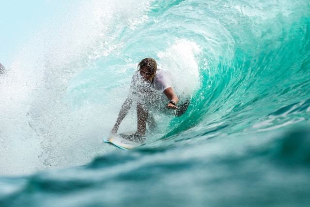 stock photo of surfer surfering through a large overlaying wave
