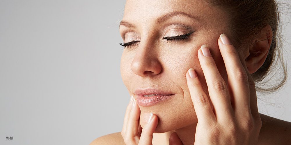 Female touching her face